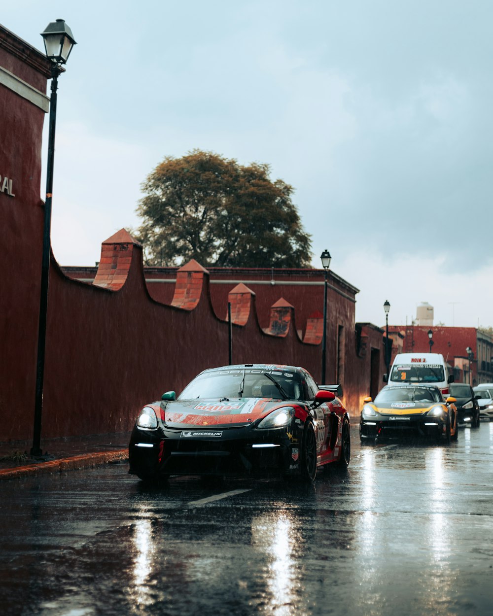 a group of cars parked on a wet street