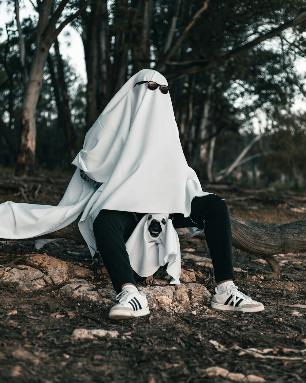 a person in a white dress lying on a tree branch