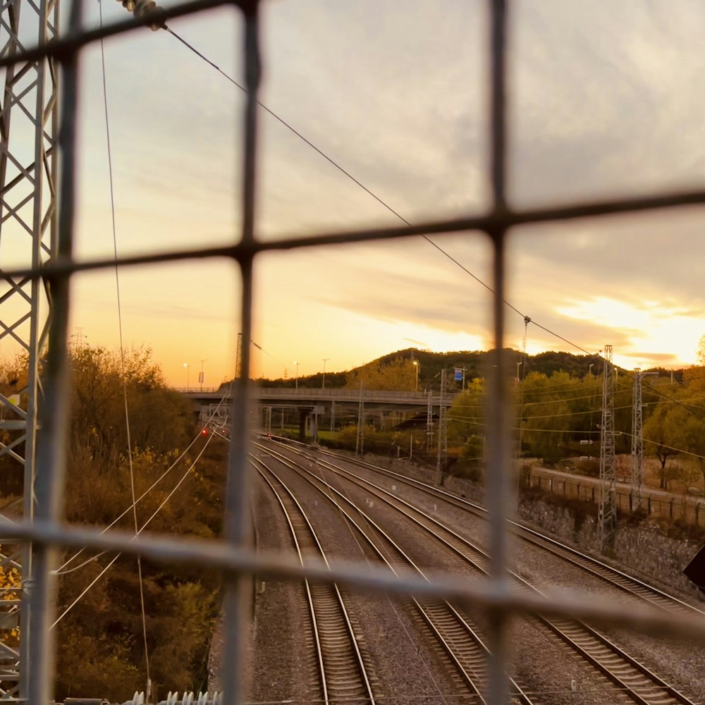 train tracks with trees and buildings in the background