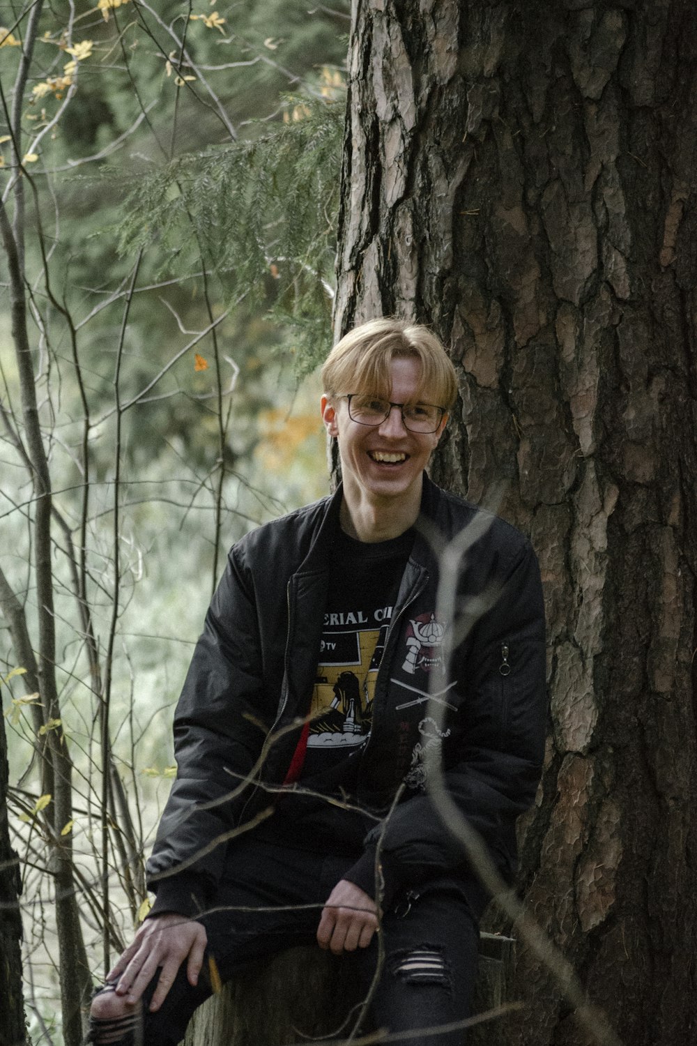 a man standing next to a tree