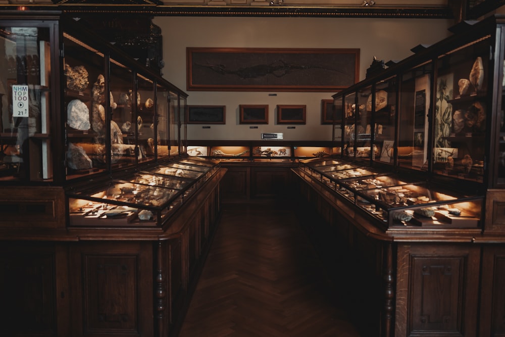 a room with a large display of antique furniture