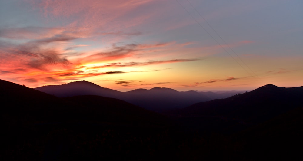 a sunset over a mountain range