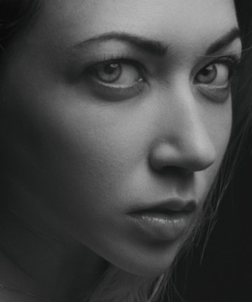 A close-up of a black and white portrait capturing intense emotion and fine details.
