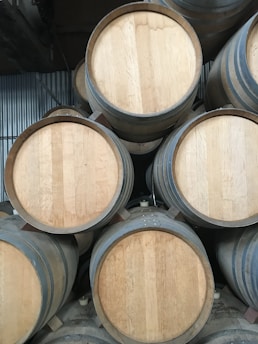 A close-up of oil barrels stacked in a warehouse, showcasing energy resources.