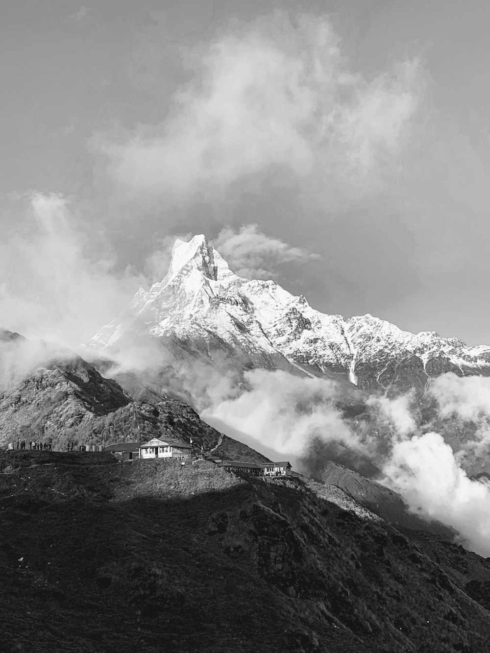 a mountain with clouds around it