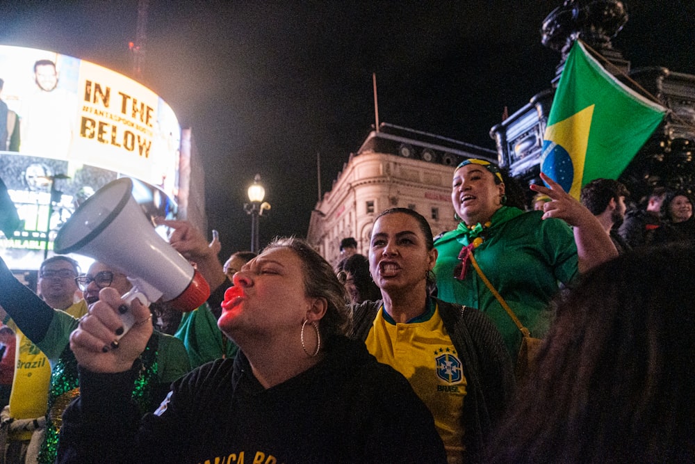 a group of people standing around each other holding a megaphone