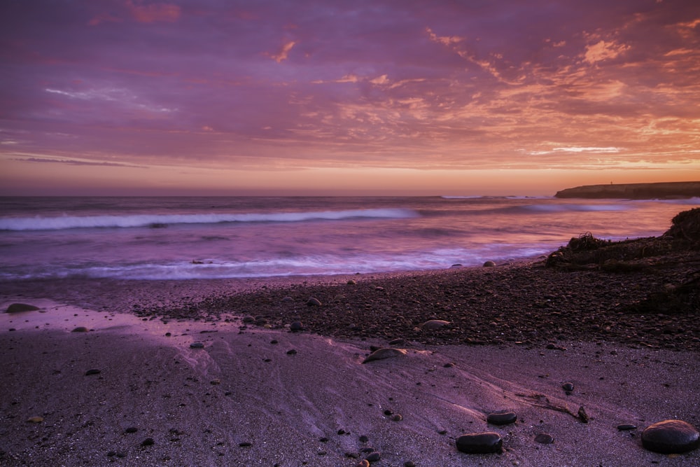 a beach with a sunset