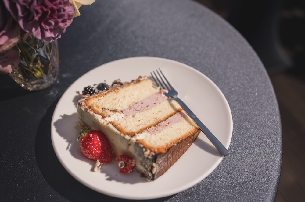 a plate of cake and a strawberry