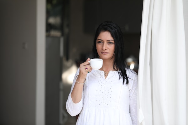 a woman holding a cup