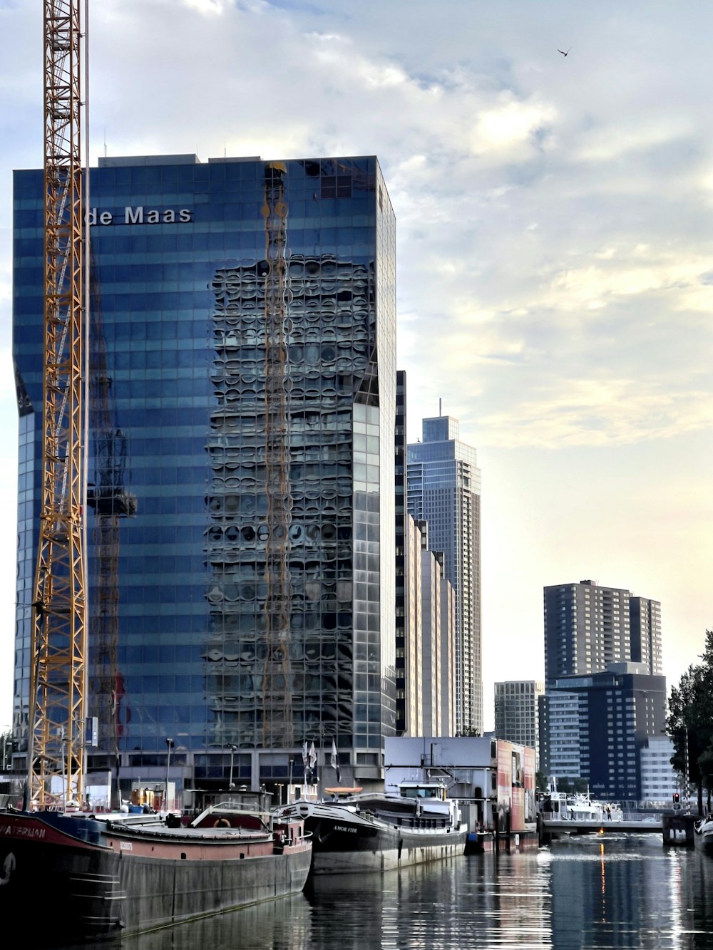 a tall building next to a body of water