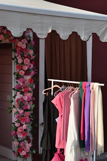 a wall with a flowered wall and a door with a flowered curtain and a flower