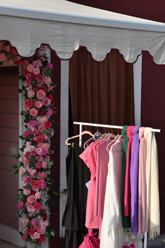 a wall with a flowered wall and a door with a flowered curtain and a flower