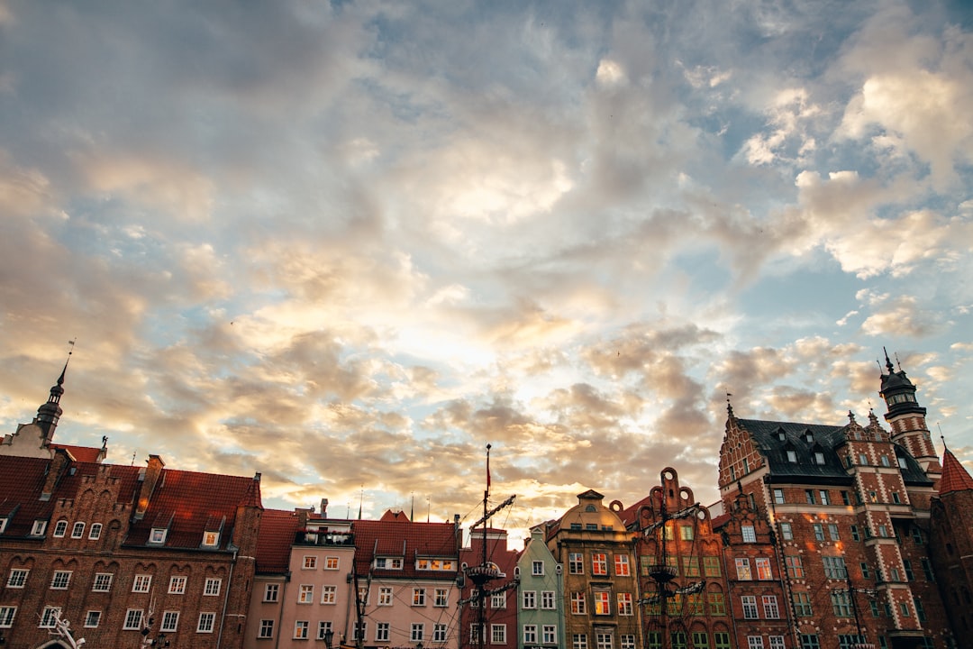 a group of buildings with clouds above,