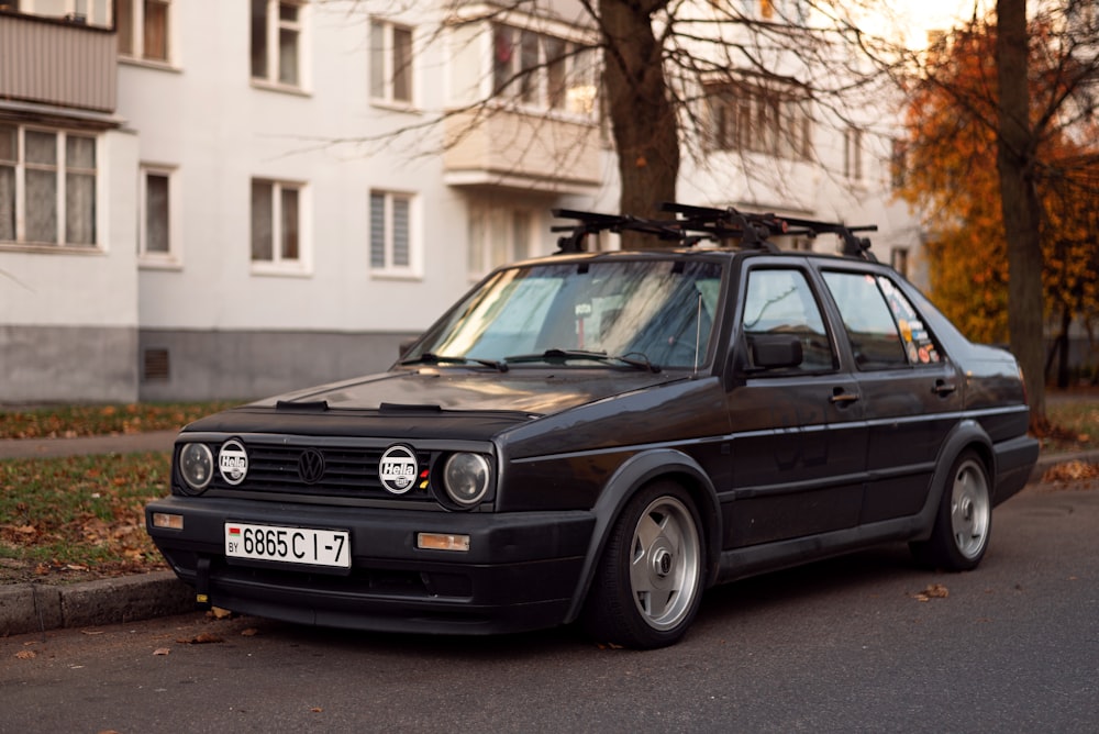 a black car parked on the side of a road