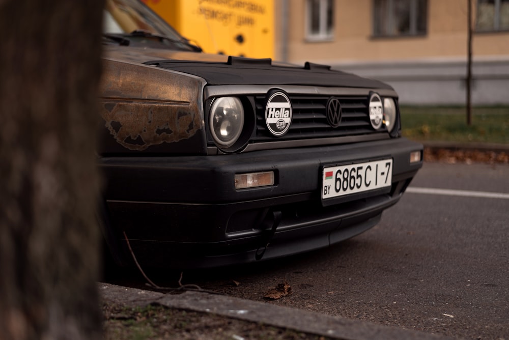 a black car parked on the side of a road