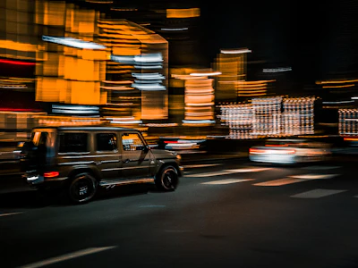 A sprinter van speeding through downtown Chicago streets with city skyline in the background.