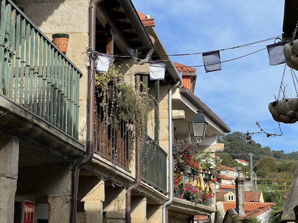 a building with plants and flowers on the side