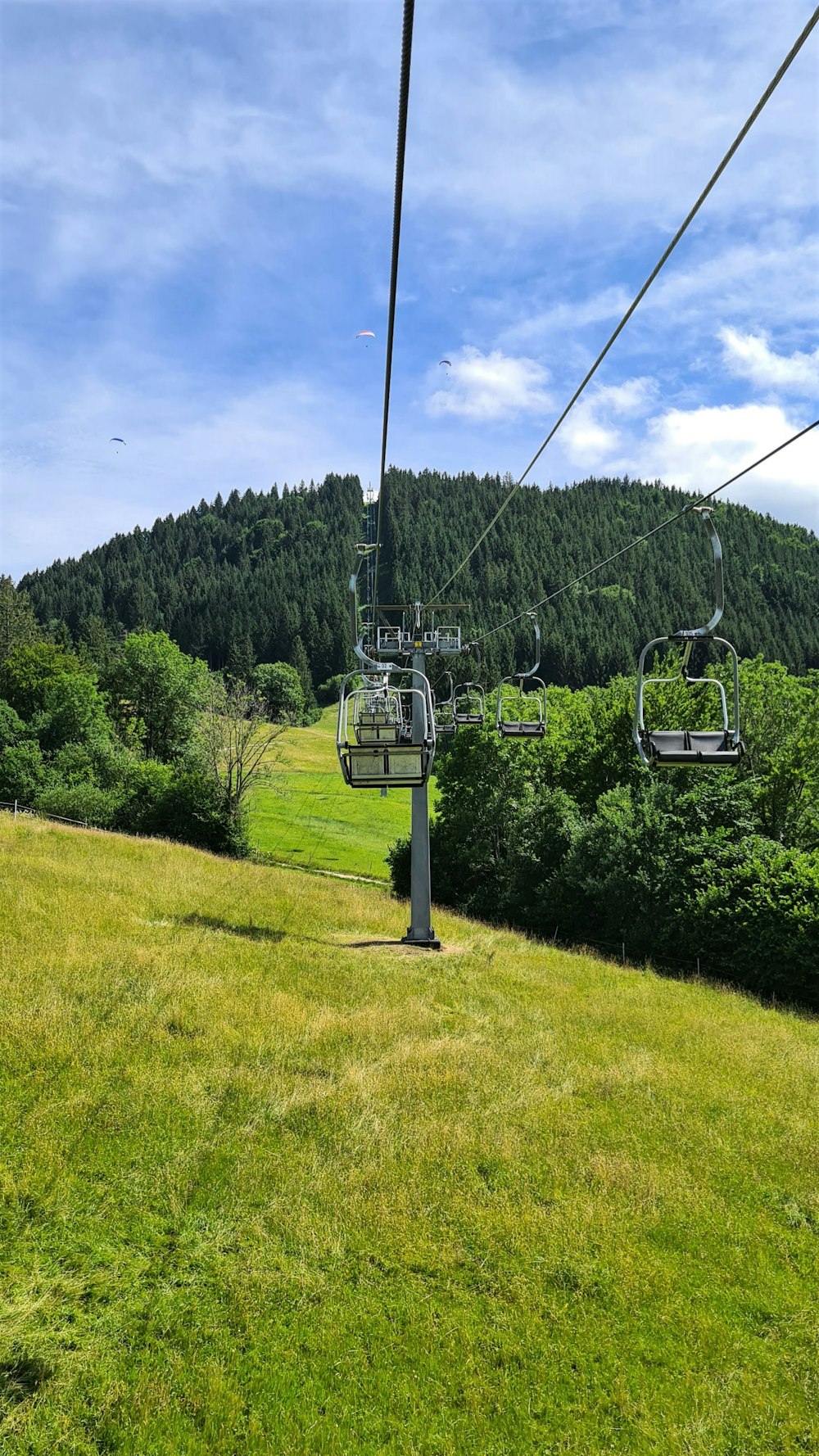 a chair lift above a grassy field
