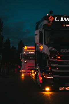 a group of trucks on a street at night