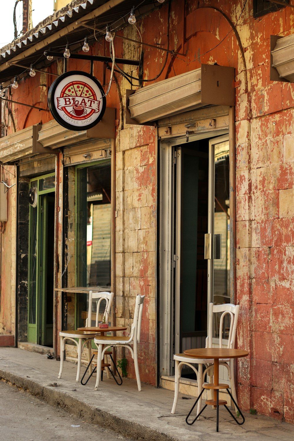 a restaurant with tables and chairs outside