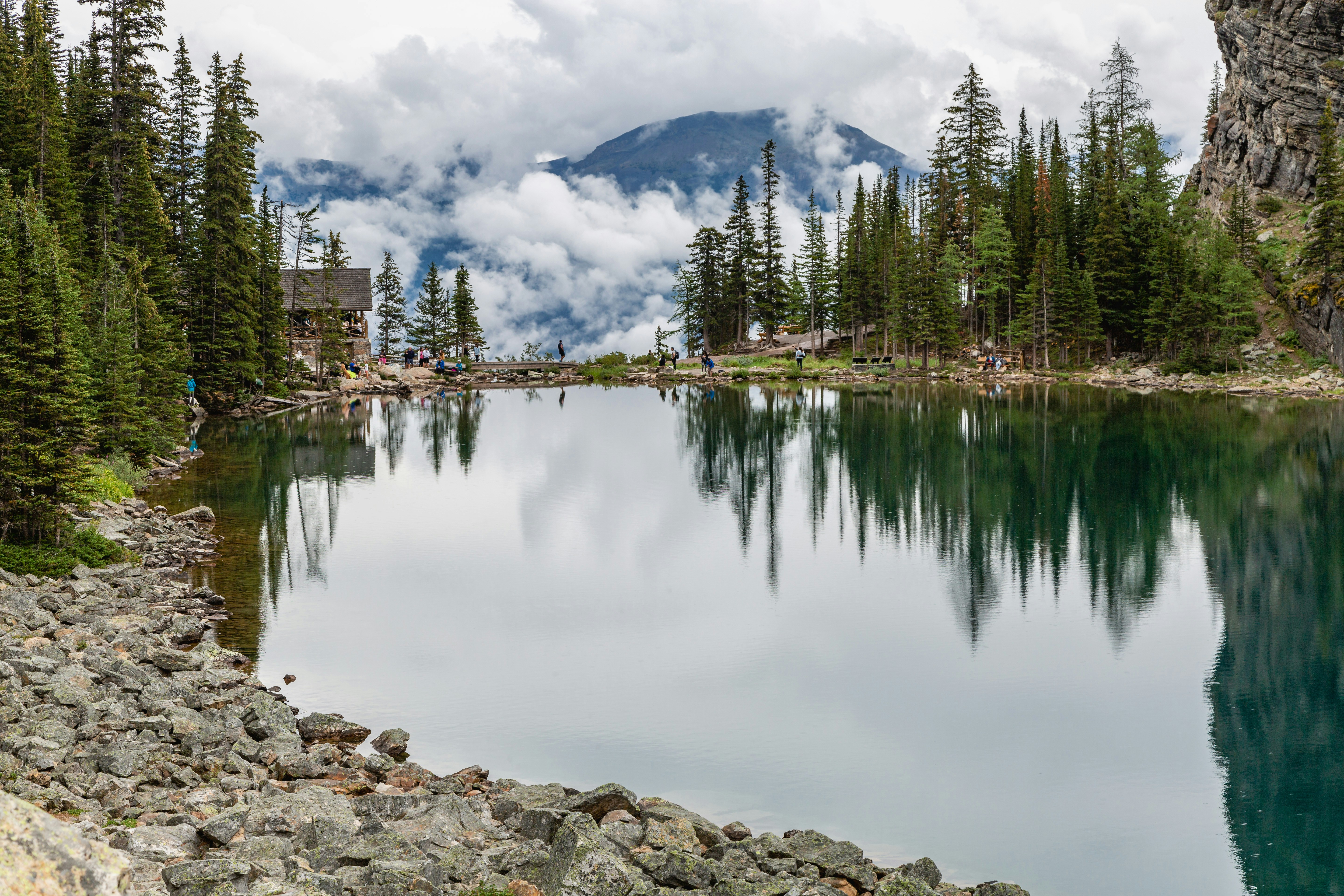 a lake surrounded by trees and mountains