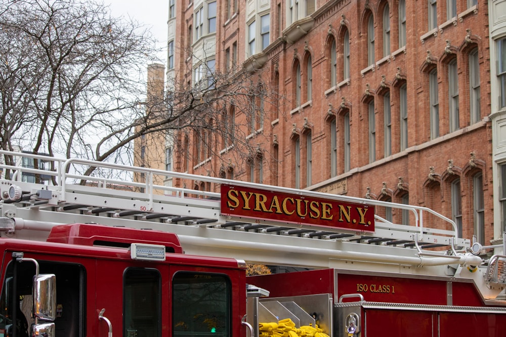 a red truck parked in front of a brick building