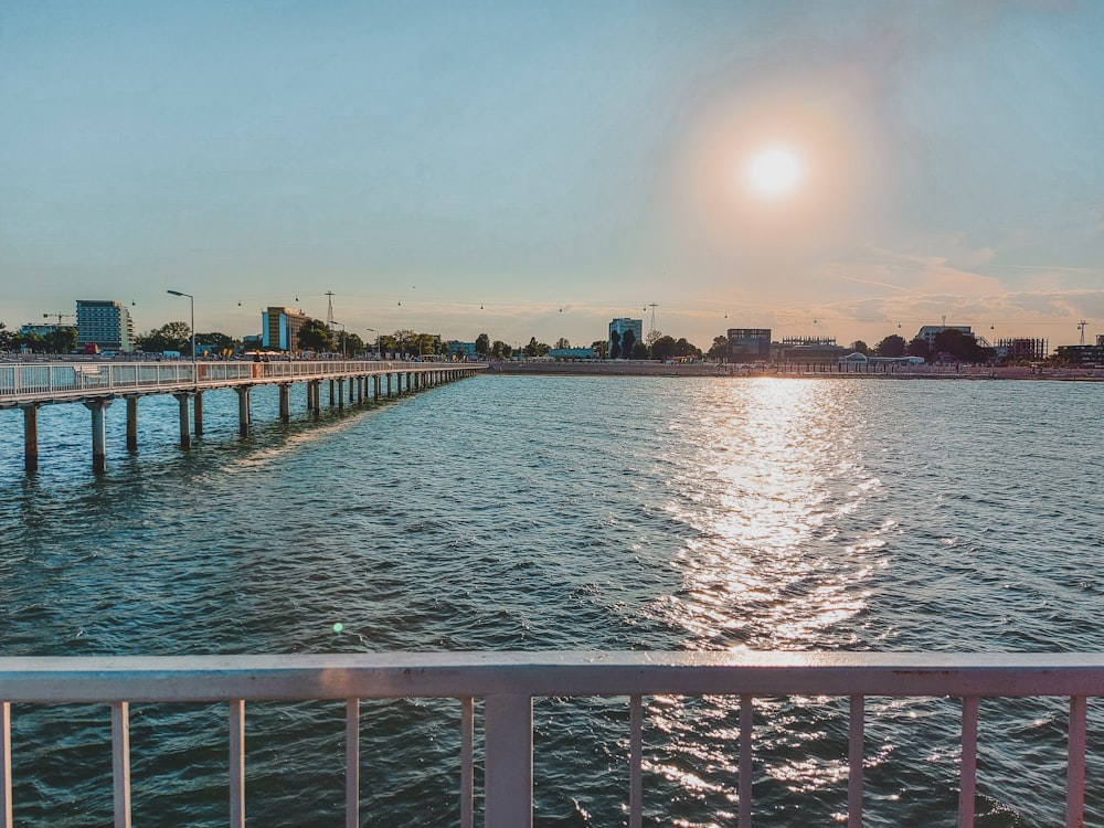 a body of water with a dock and buildings in the background