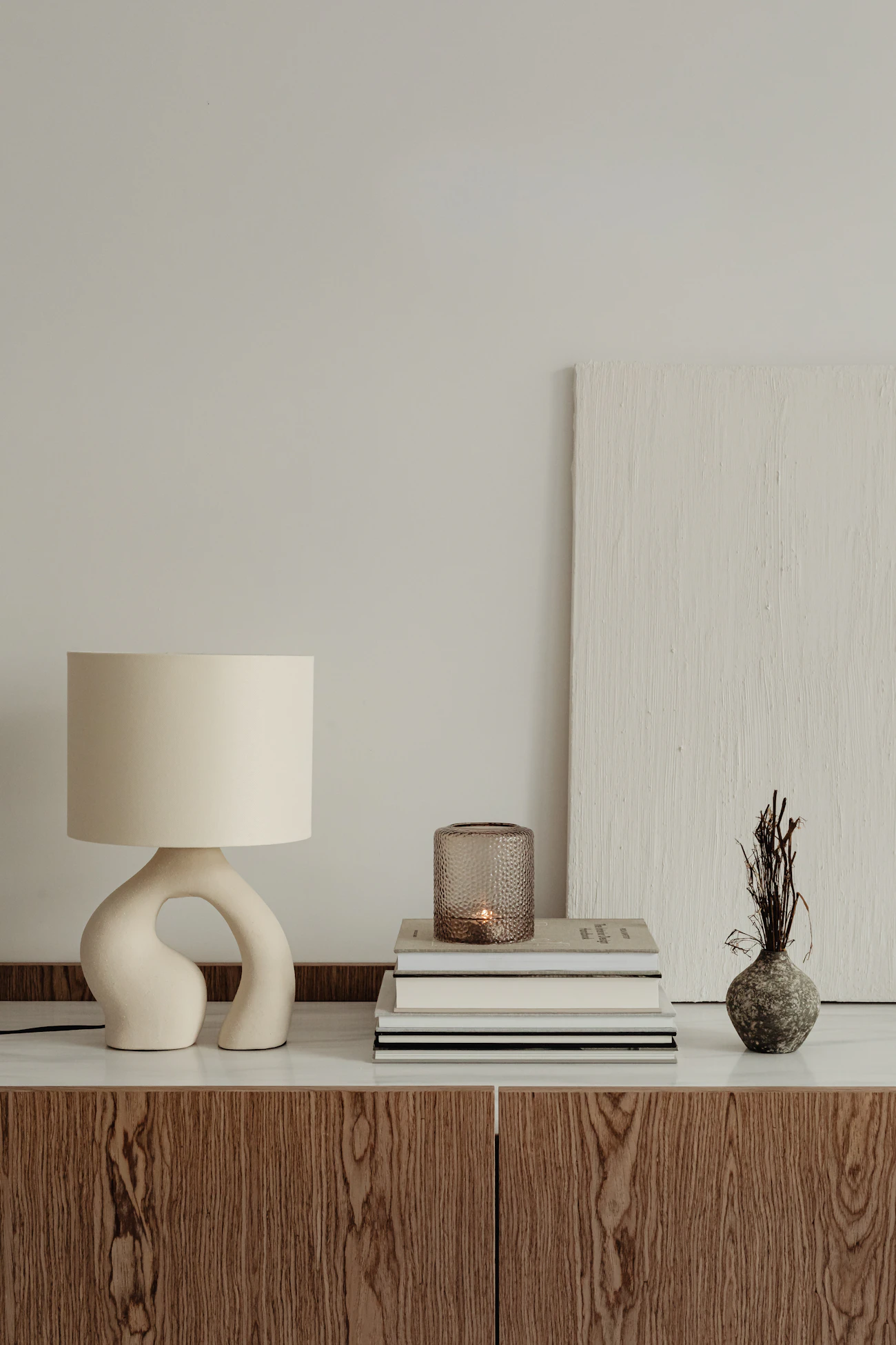 A lamp and books on a table