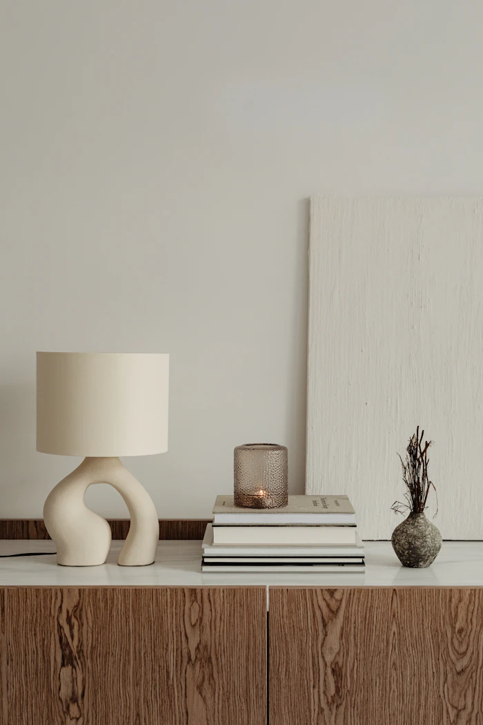 A lamp and a stack of books on a table
