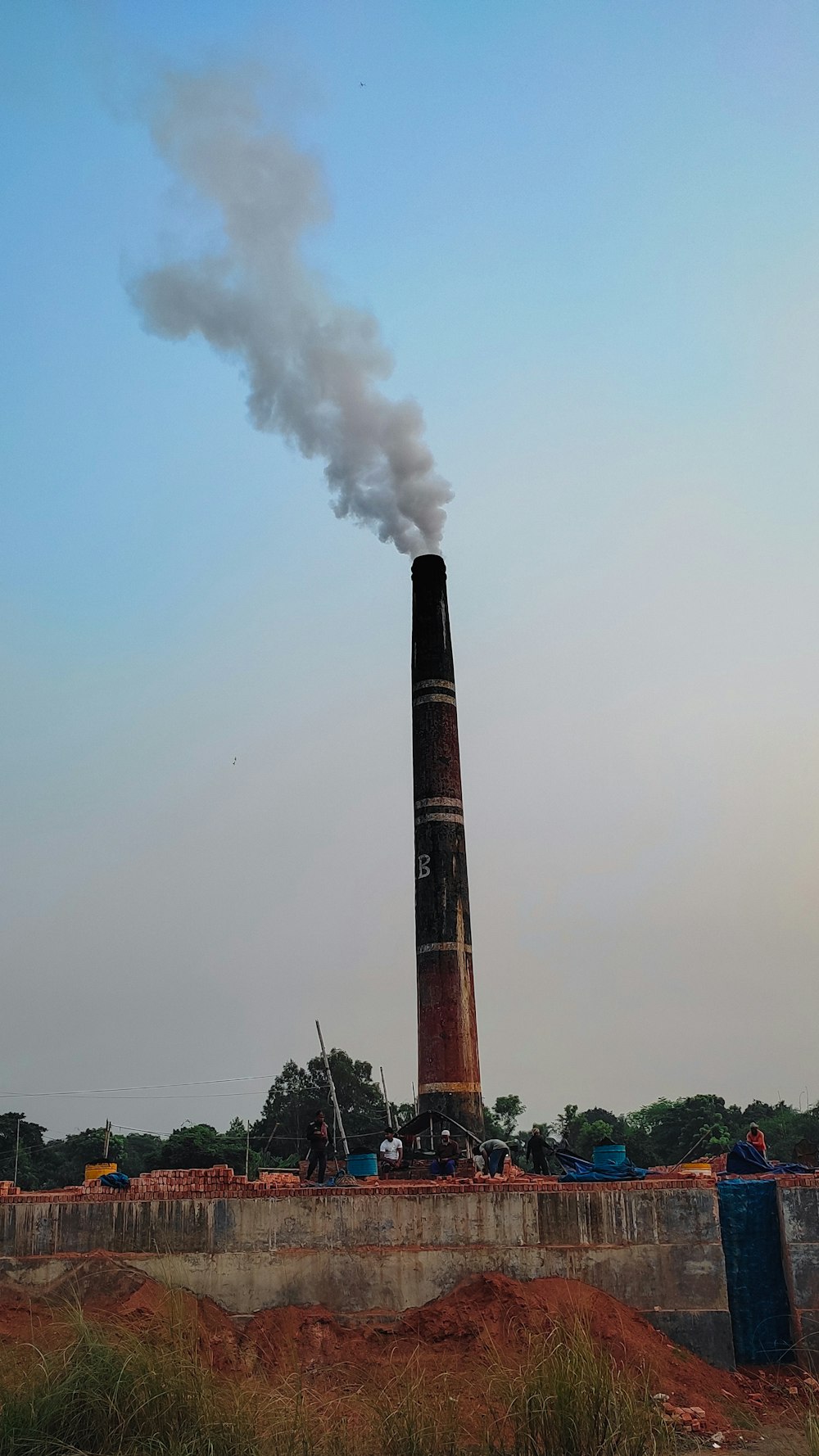 a large tower with smoke coming out of it