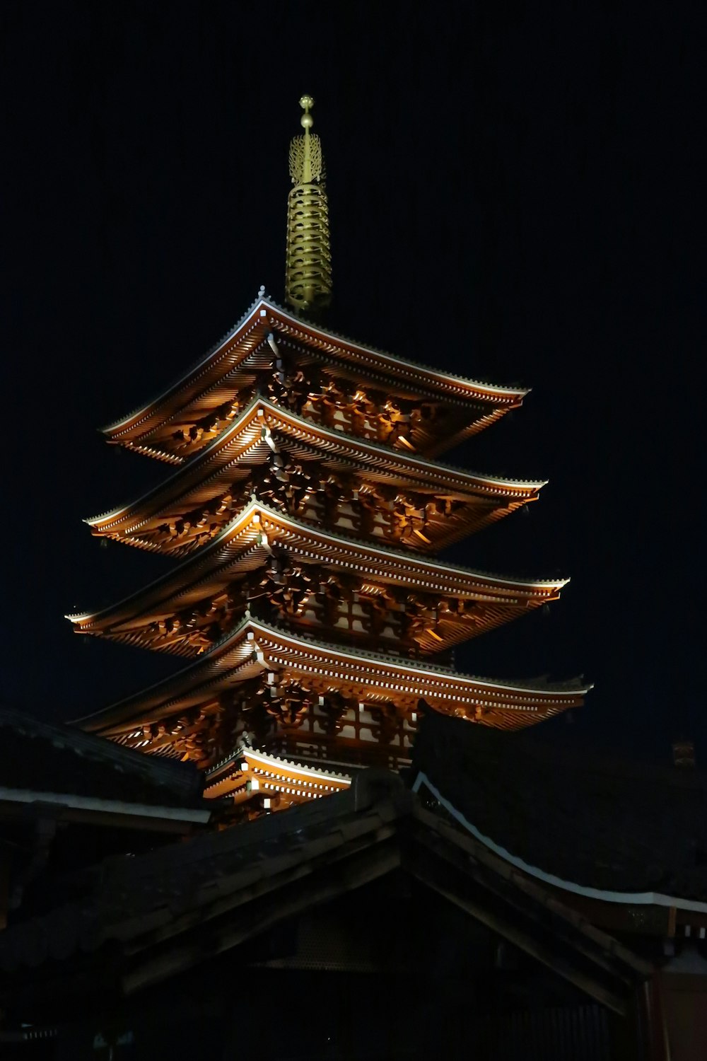 a tall tower with a gold top