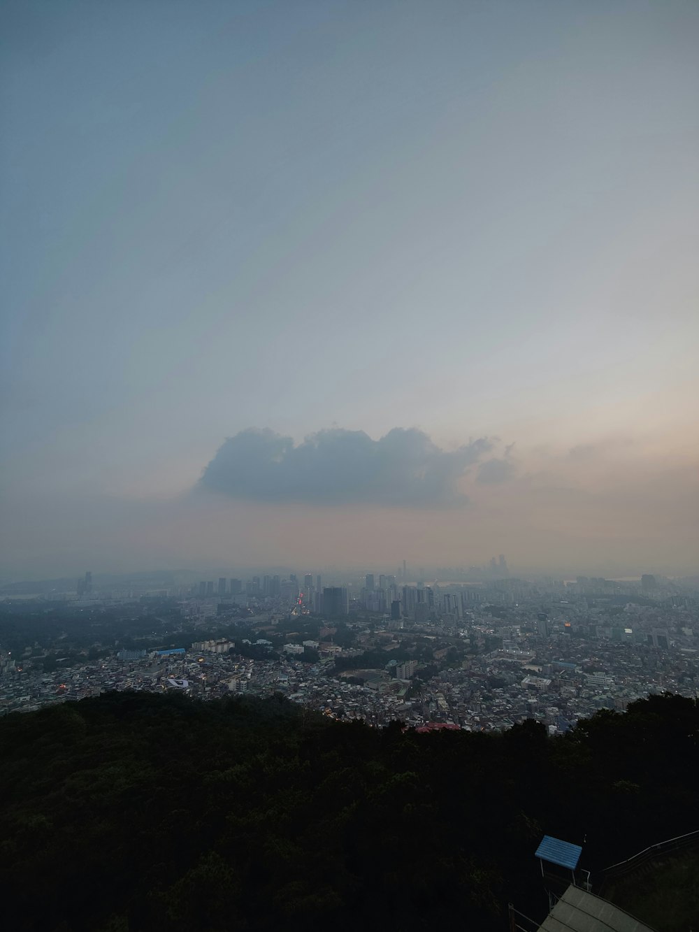 a city with a large cloud in the sky