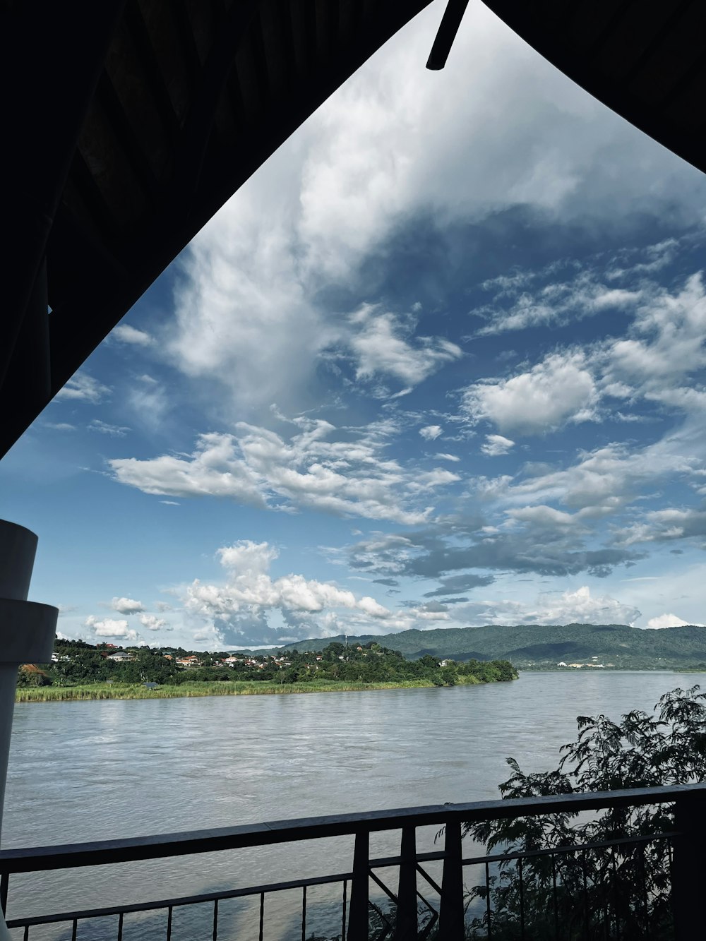 a view of a lake and land from a balcony