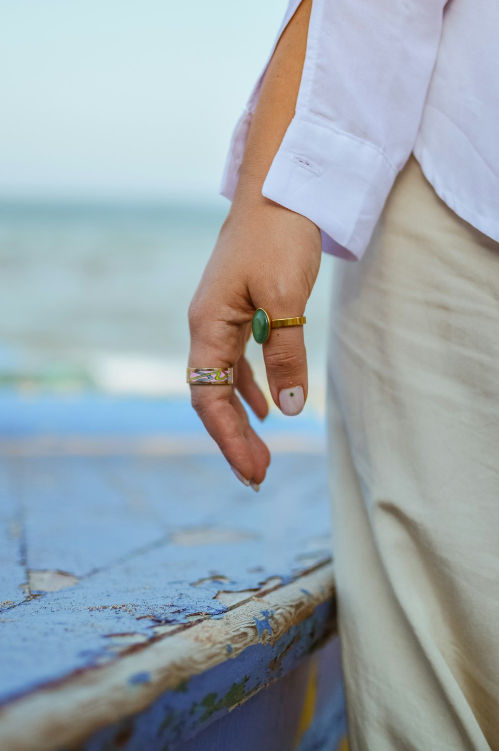 a person's hand with a ring on it