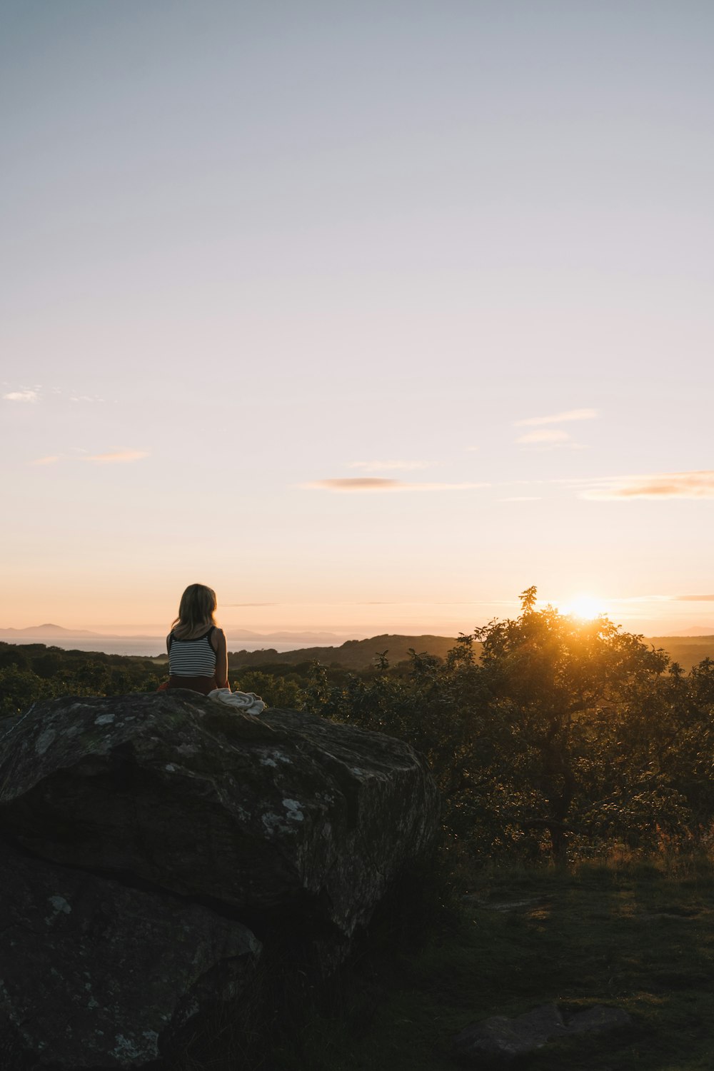 a man sitting on a rock