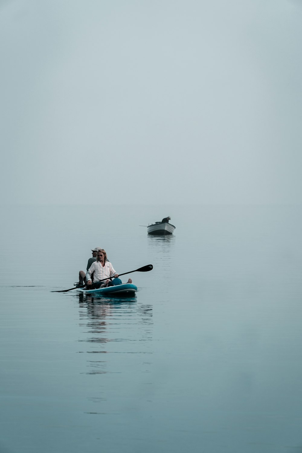 a person and a dog rowing a boat