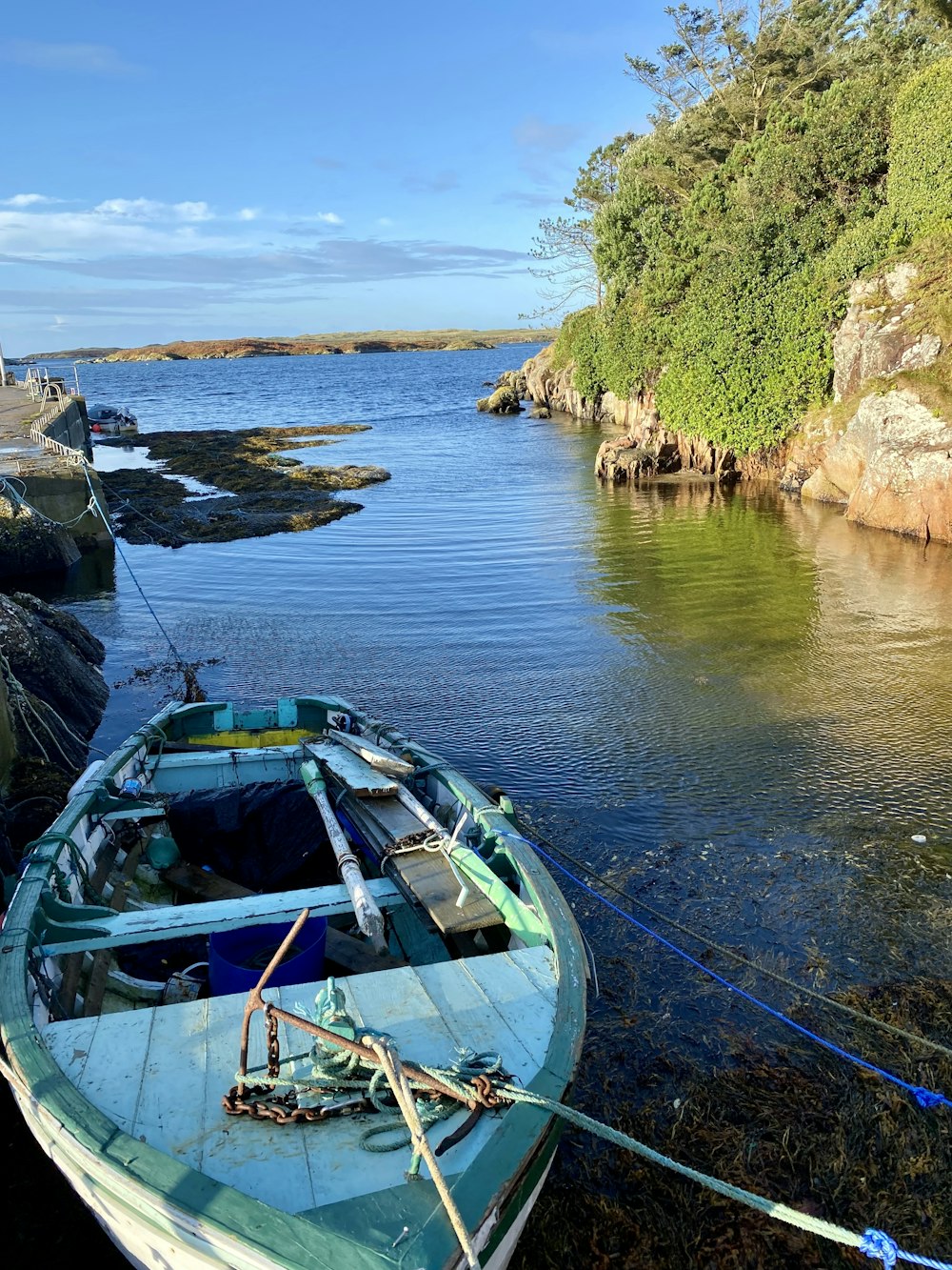 a boat tied to a rock wall