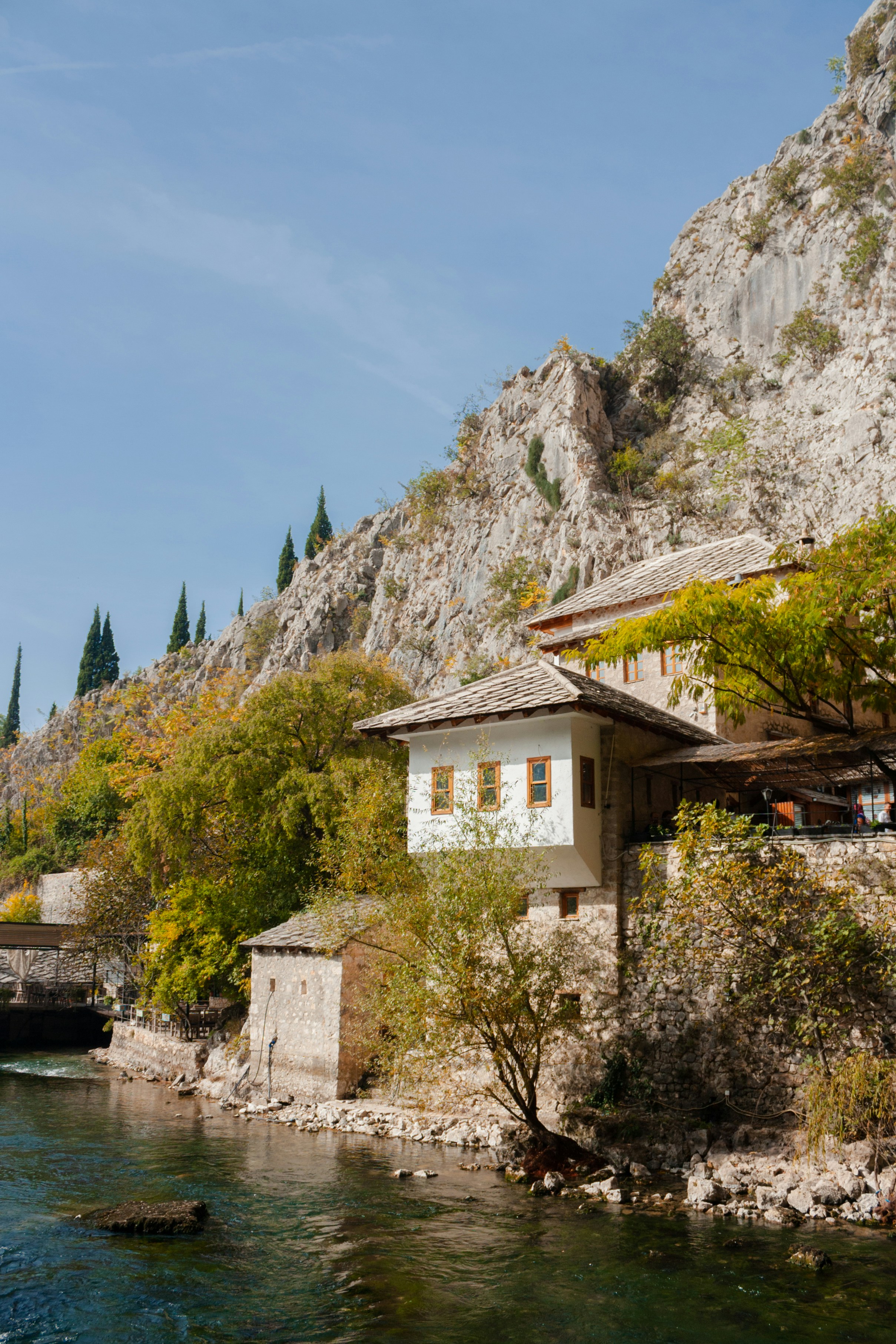 a house on a cliff by a river