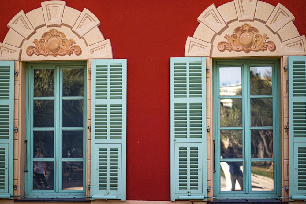 a couple of doors with a dog in the window