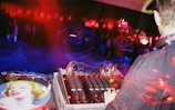 A female DJ intensely mixing tracks on her turntables under vibrant club lights.