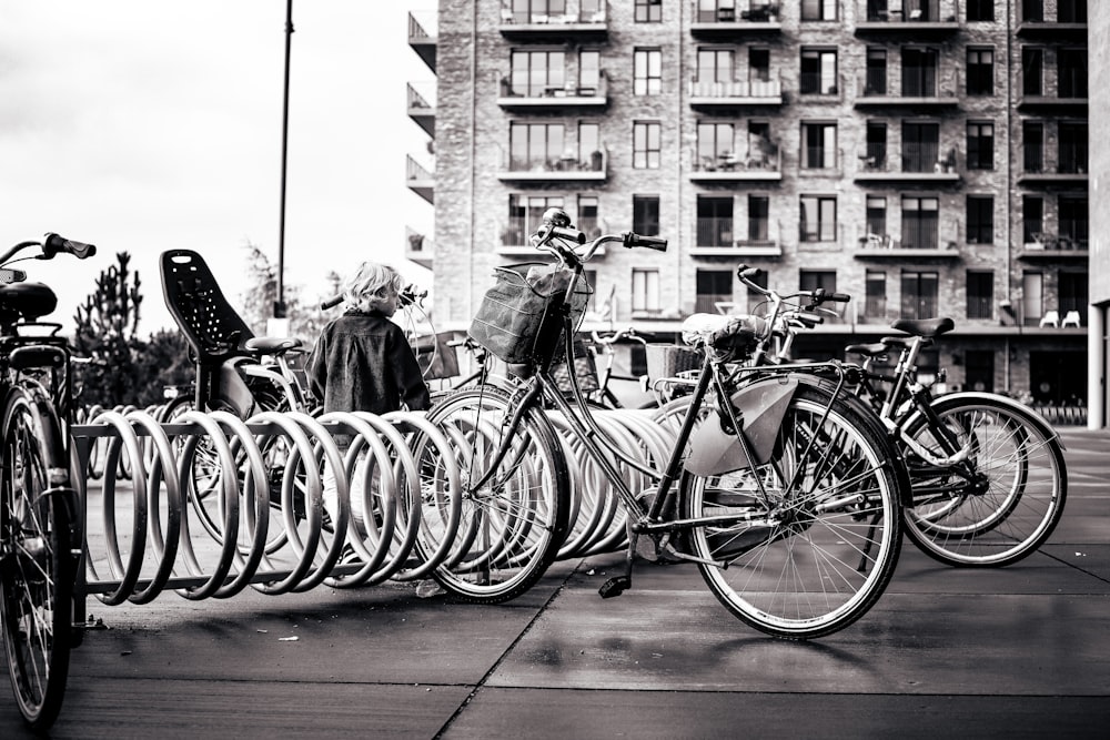 a person stands next to a row of bicycles