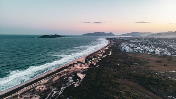A beach with a town by it — Florianópolis, Brazil