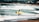 a man carrying a surfboard on a beach