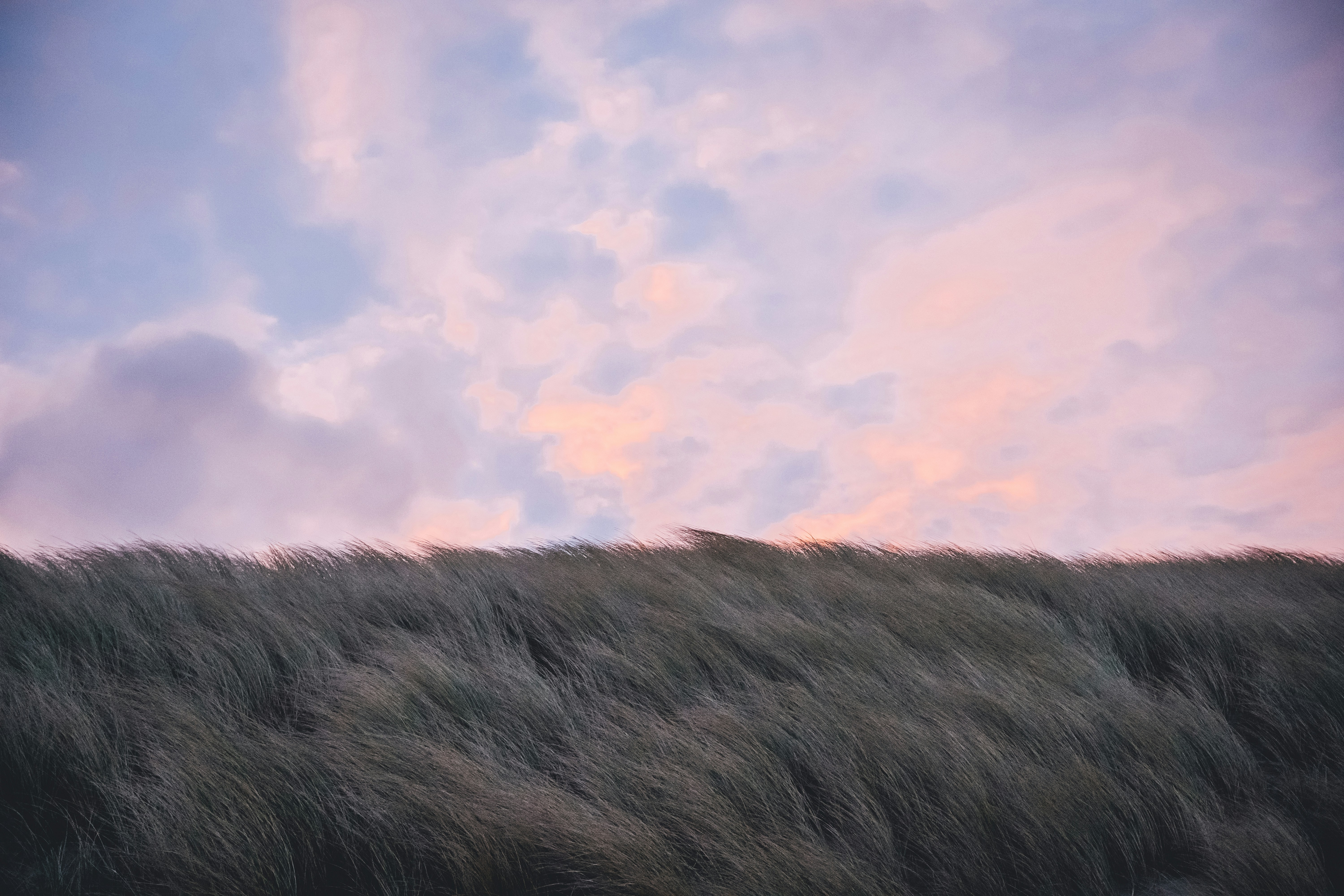 a hill with a cloudy sky