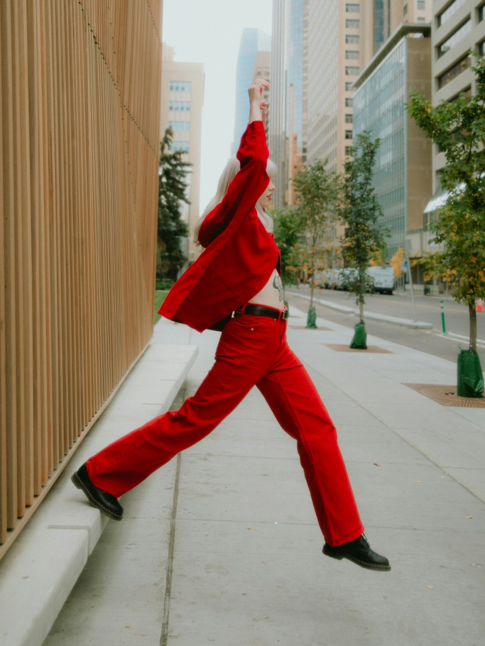 a person in red pants and a red outfit jumping in the air