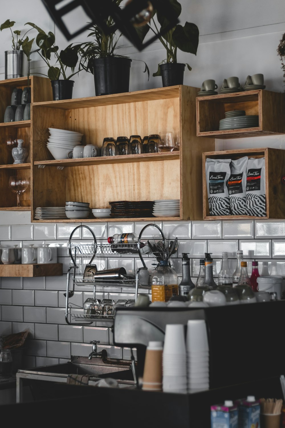 a kitchen with a shelf full of dishes