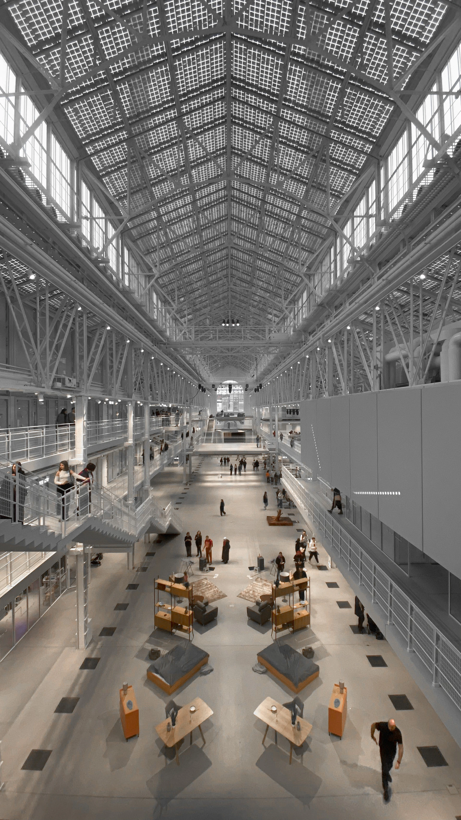 Attendees engaging in lively conversations in front of a striking architectural aluminum frame installation inside the expo venue.