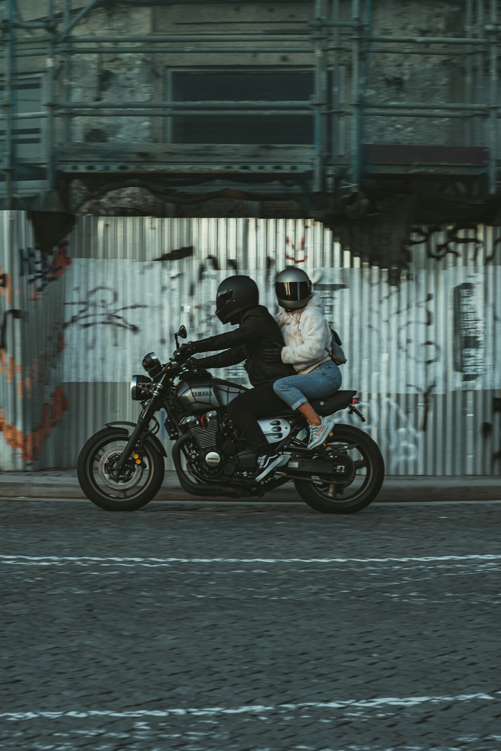 a man and a woman riding a motorcycle