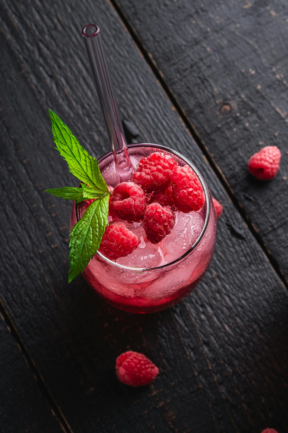 a red bowl with strawberries in it