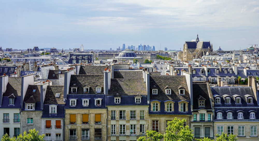 a group of buildings with trees in the front